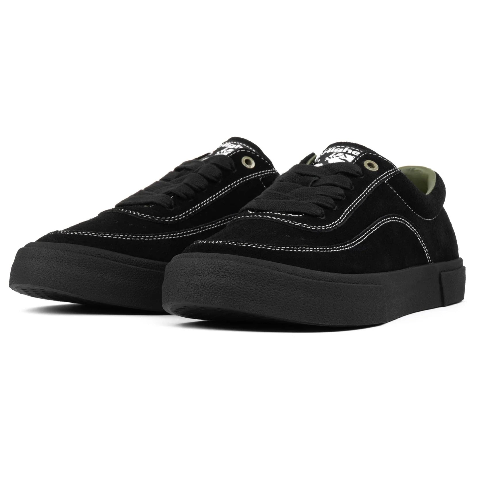 Black higher footwear sneakers with white stitching on a white background