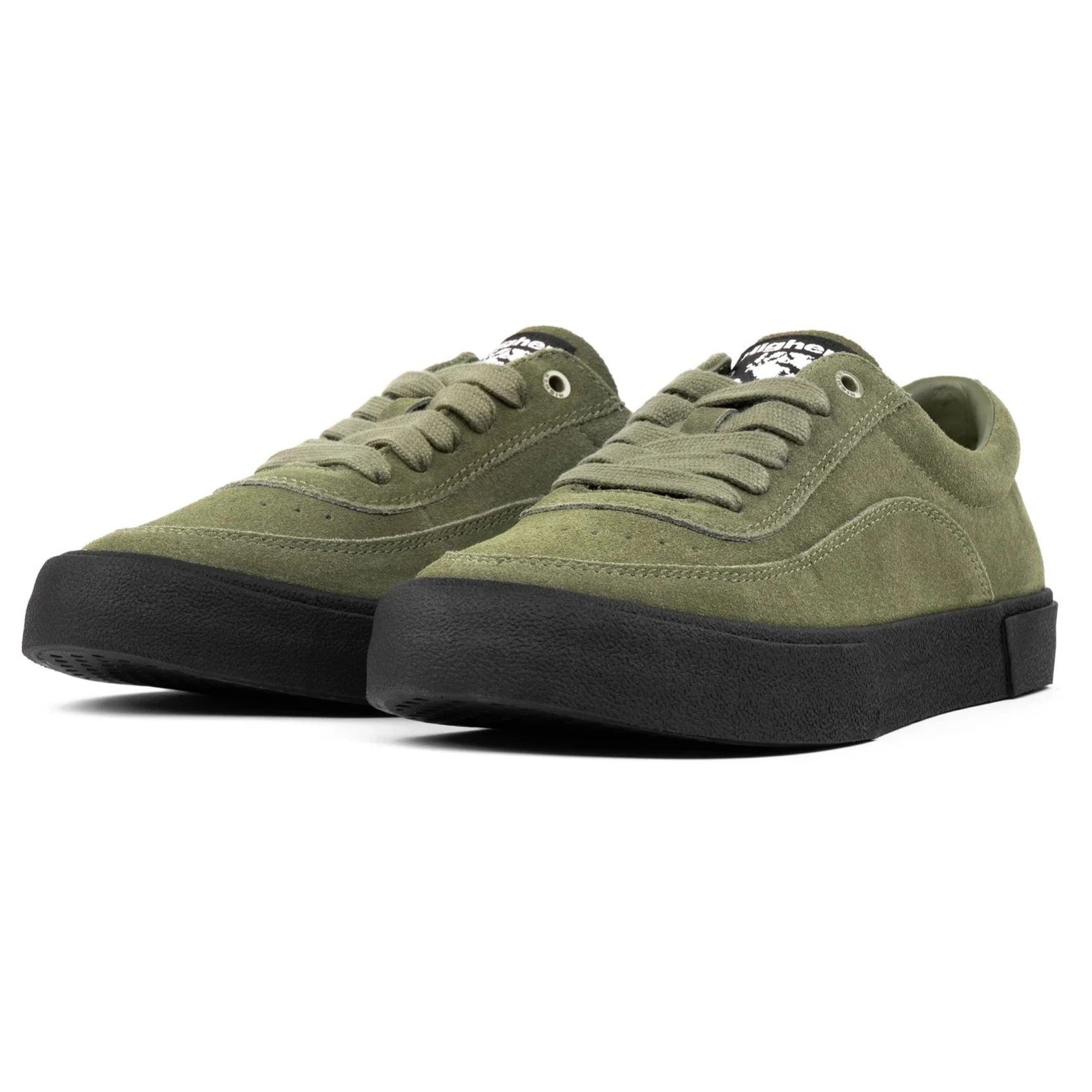 Pair of green higher footwear sneakers with black soles on a white background